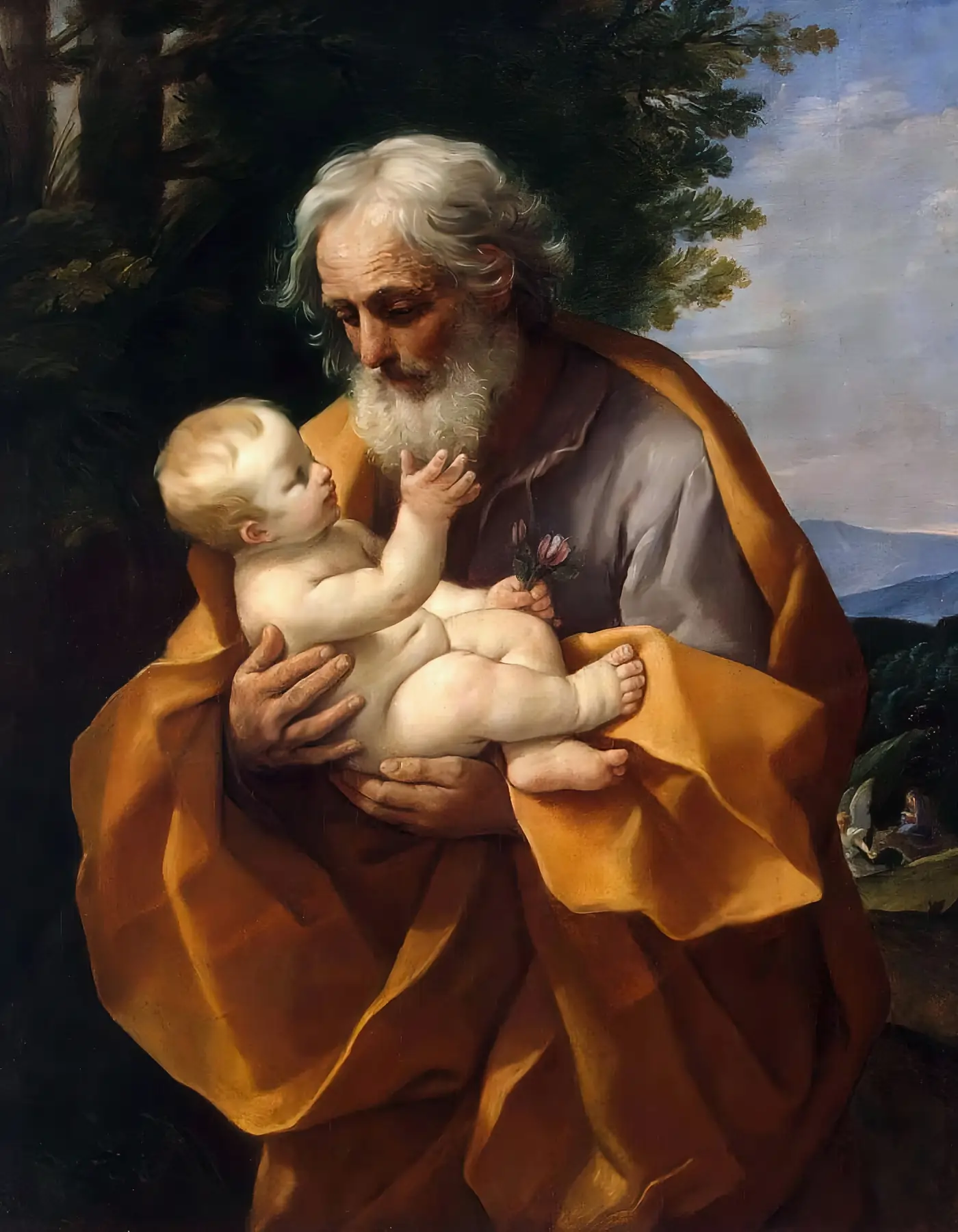 An image of St. Joseph holding baby Jesus lovingly